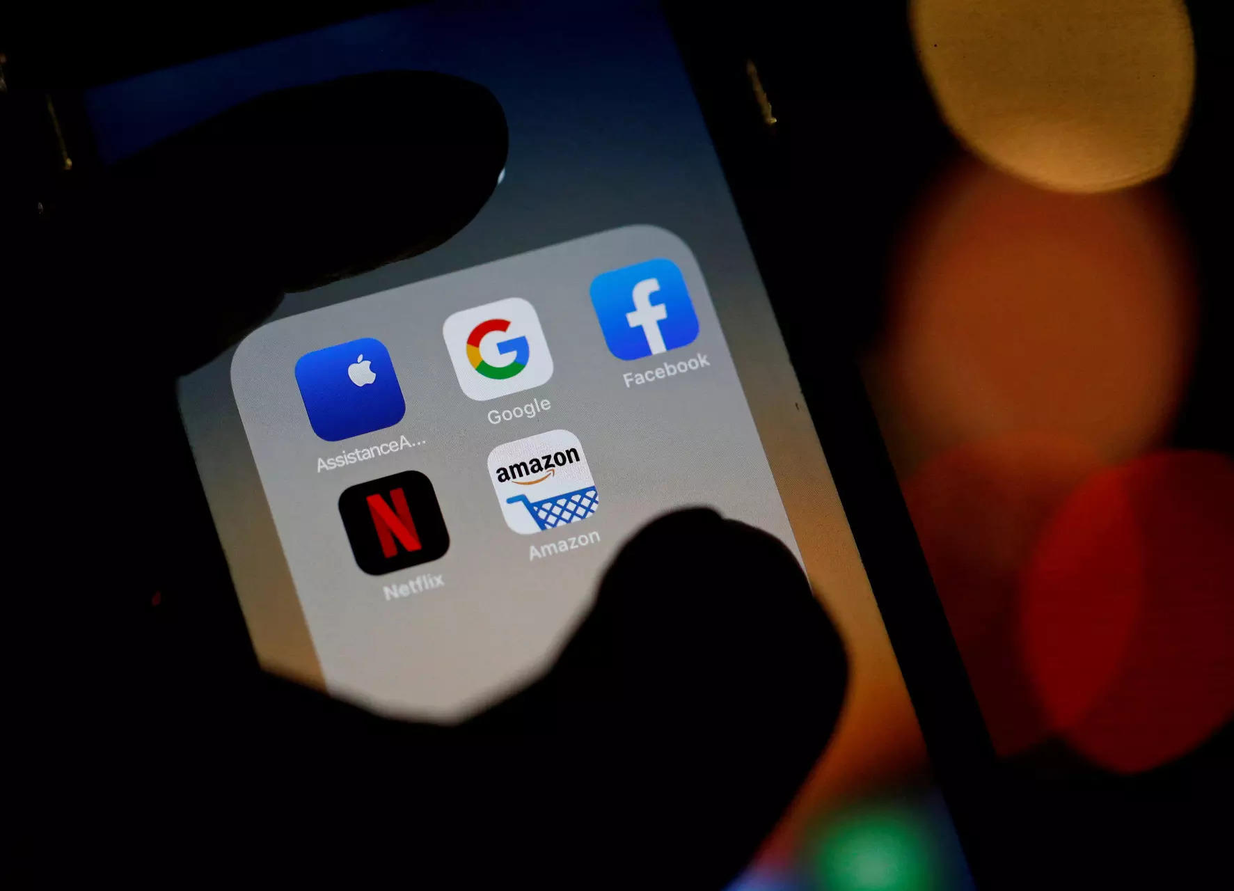 FILE PHOTO: The logos of mobile apps, Google, Amazon, Facebook, Apple and Netflix, are displayed on a screen in this illustration picture
